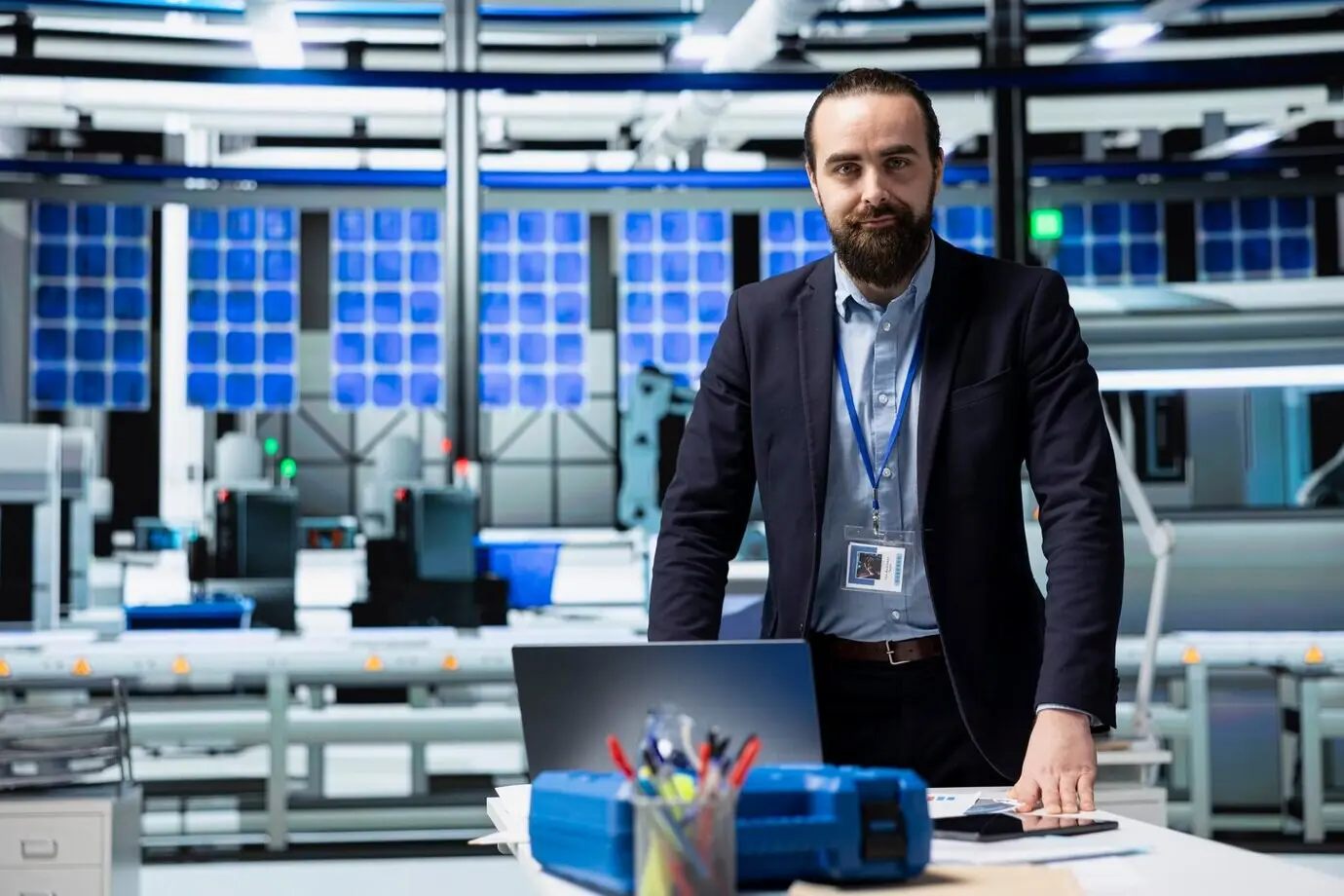 An industrial consultant inspects a high-tech solar energy production line.